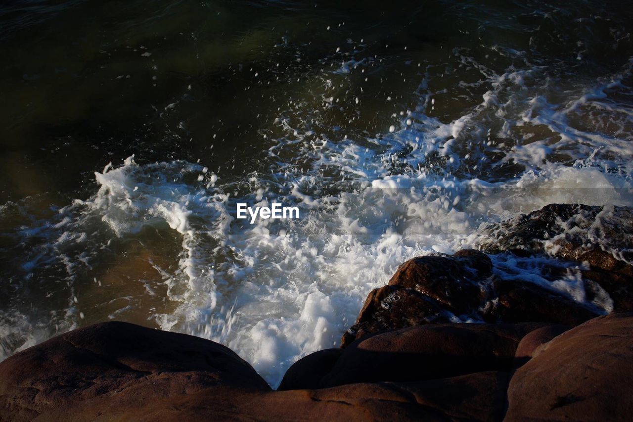 WAVES SPLASHING ON ROCKS