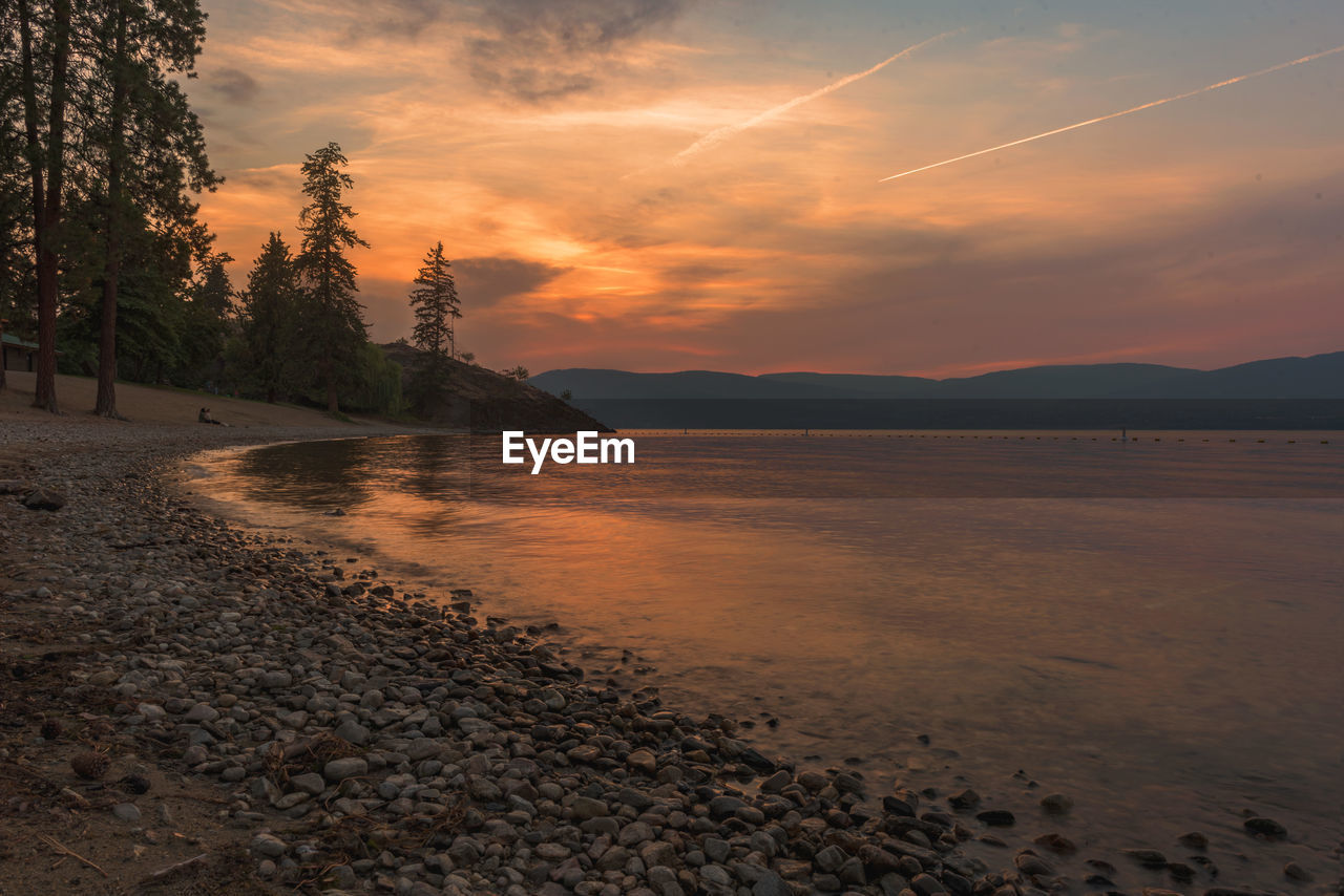 Scenic view of beach against sky during sunset