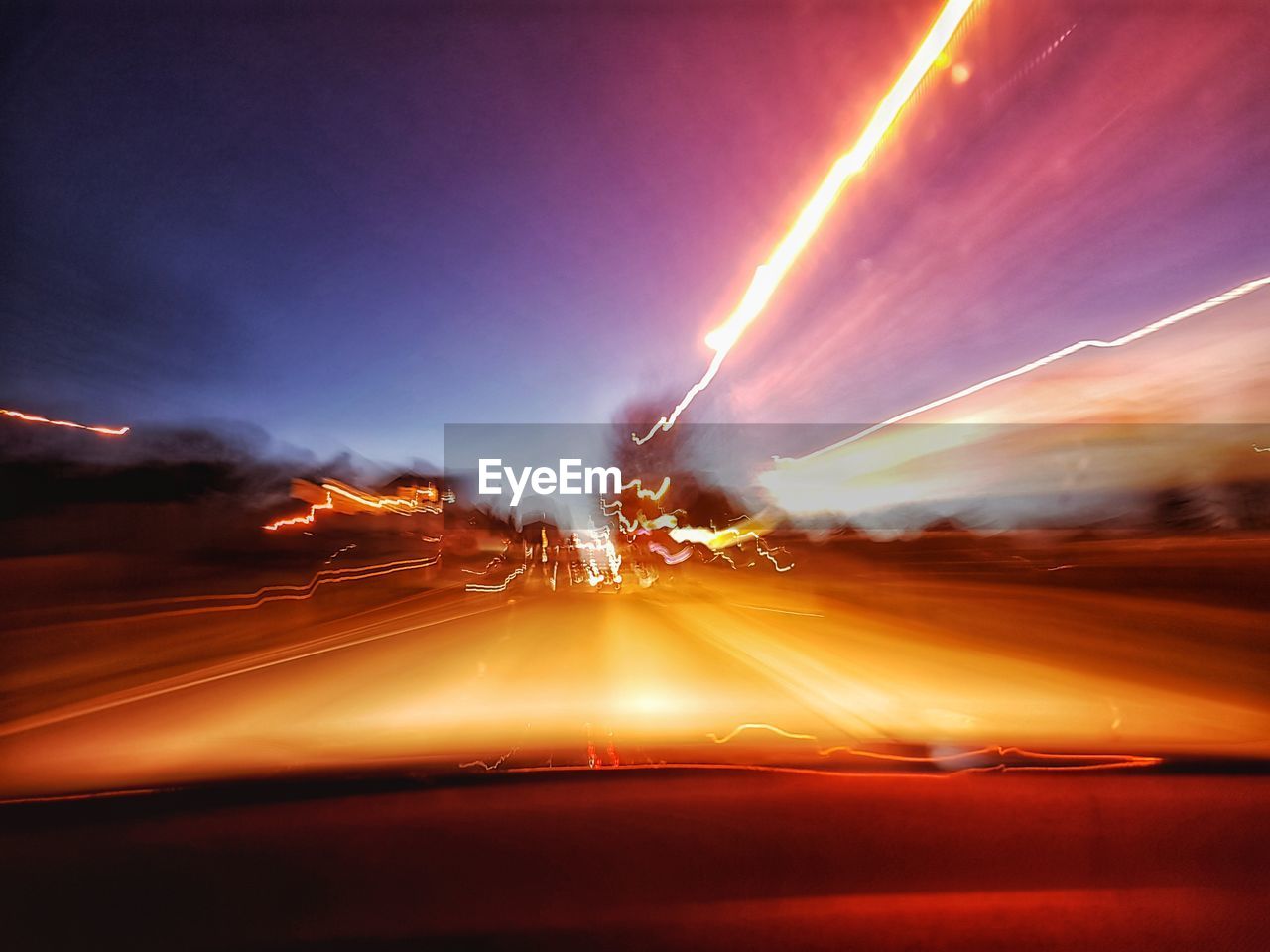 LIGHT TRAILS ON ROAD AT NIGHT