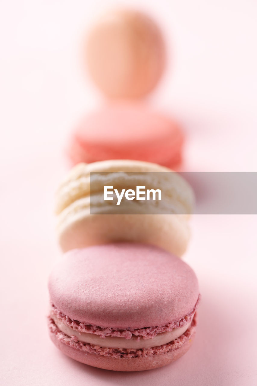 Close-up of macaroons against white background