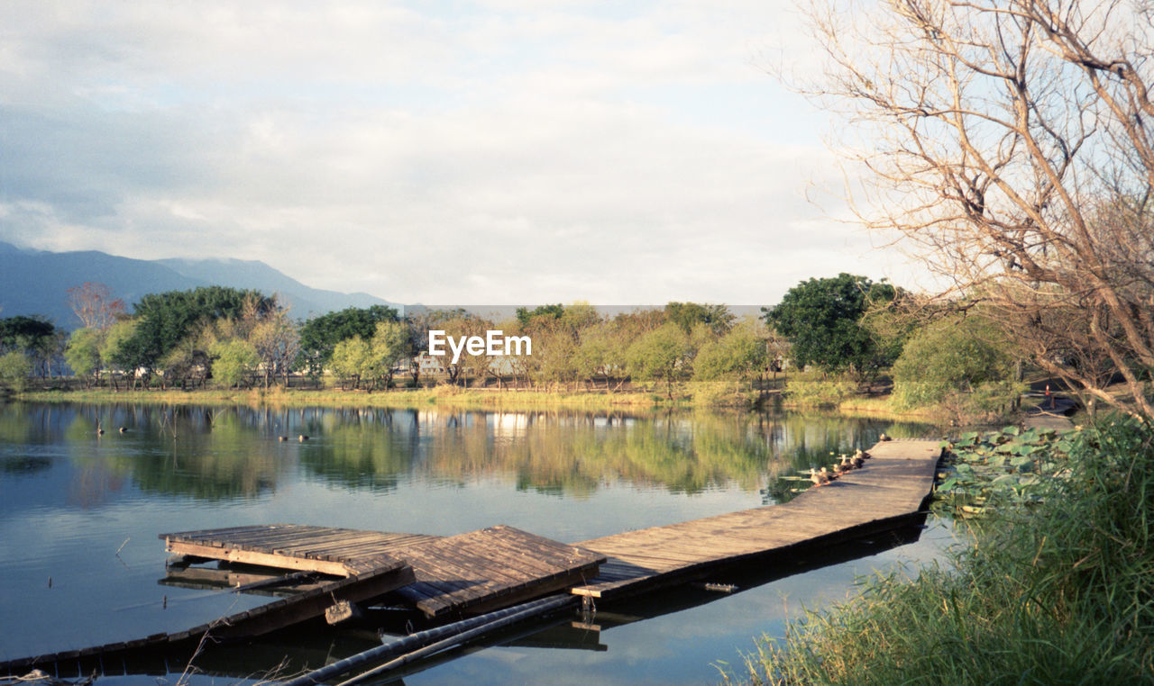 water, reflection, tree, river, plant, nature, sky, tranquility, beauty in nature, scenics - nature, tranquil scene, no people, reservoir, body of water, cloud, day, waterway, environment, outdoors, nautical vessel, autumn, landscape, non-urban scene, travel destinations, transportation, architecture, travel