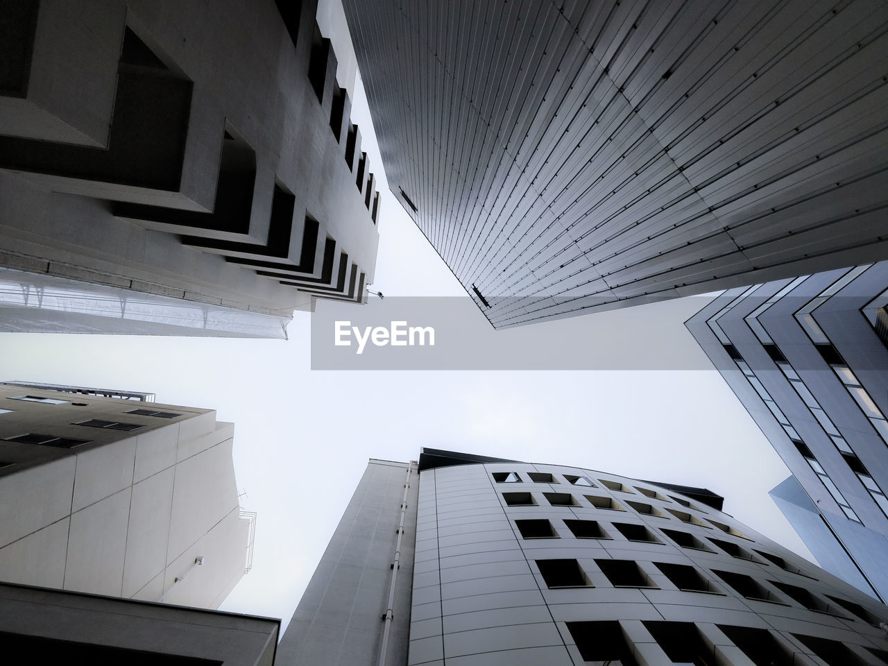 LOW ANGLE VIEW OF MODERN BUILDINGS AGAINST CLEAR SKY