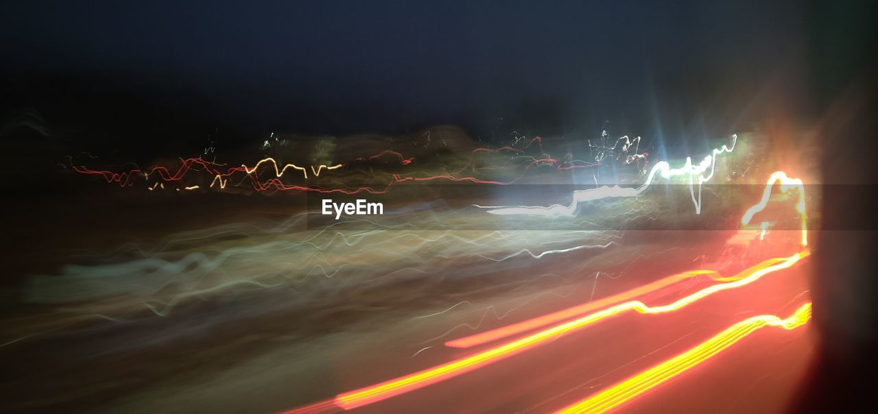 LIGHT TRAILS IN ILLUMINATED AT NIGHT