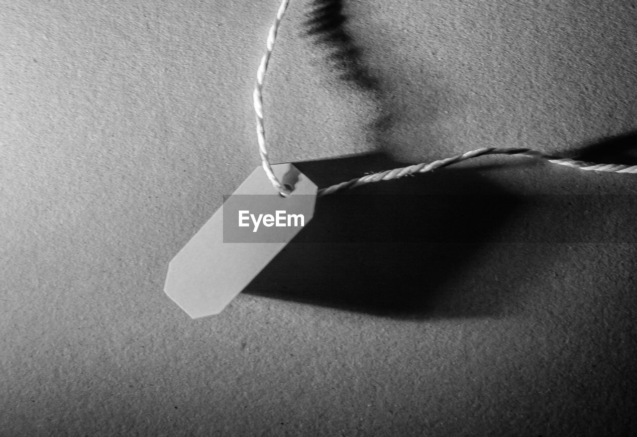 CLOSE-UP OF A SHADOW OF WOMAN WITH HAND ON FLOOR