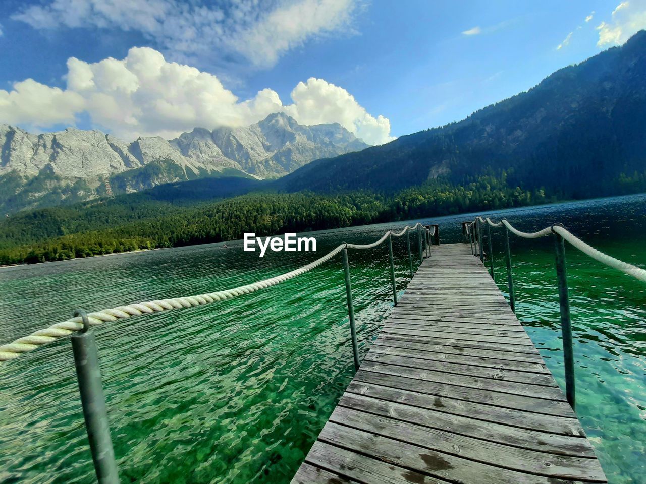 WOODEN PIER OVER LAKE AGAINST SKY