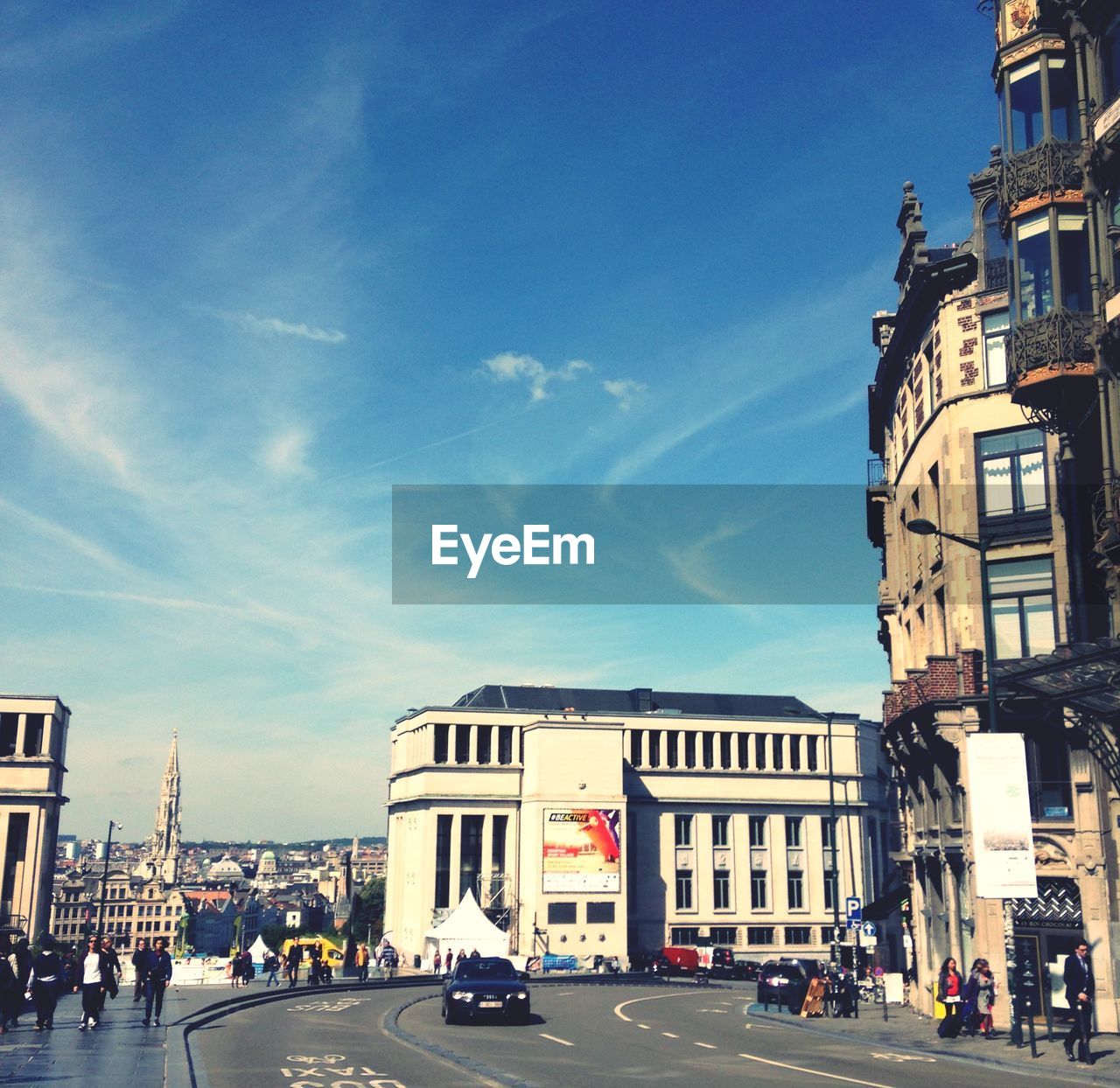 VIEW OF CITY STREET AGAINST BLUE SKY