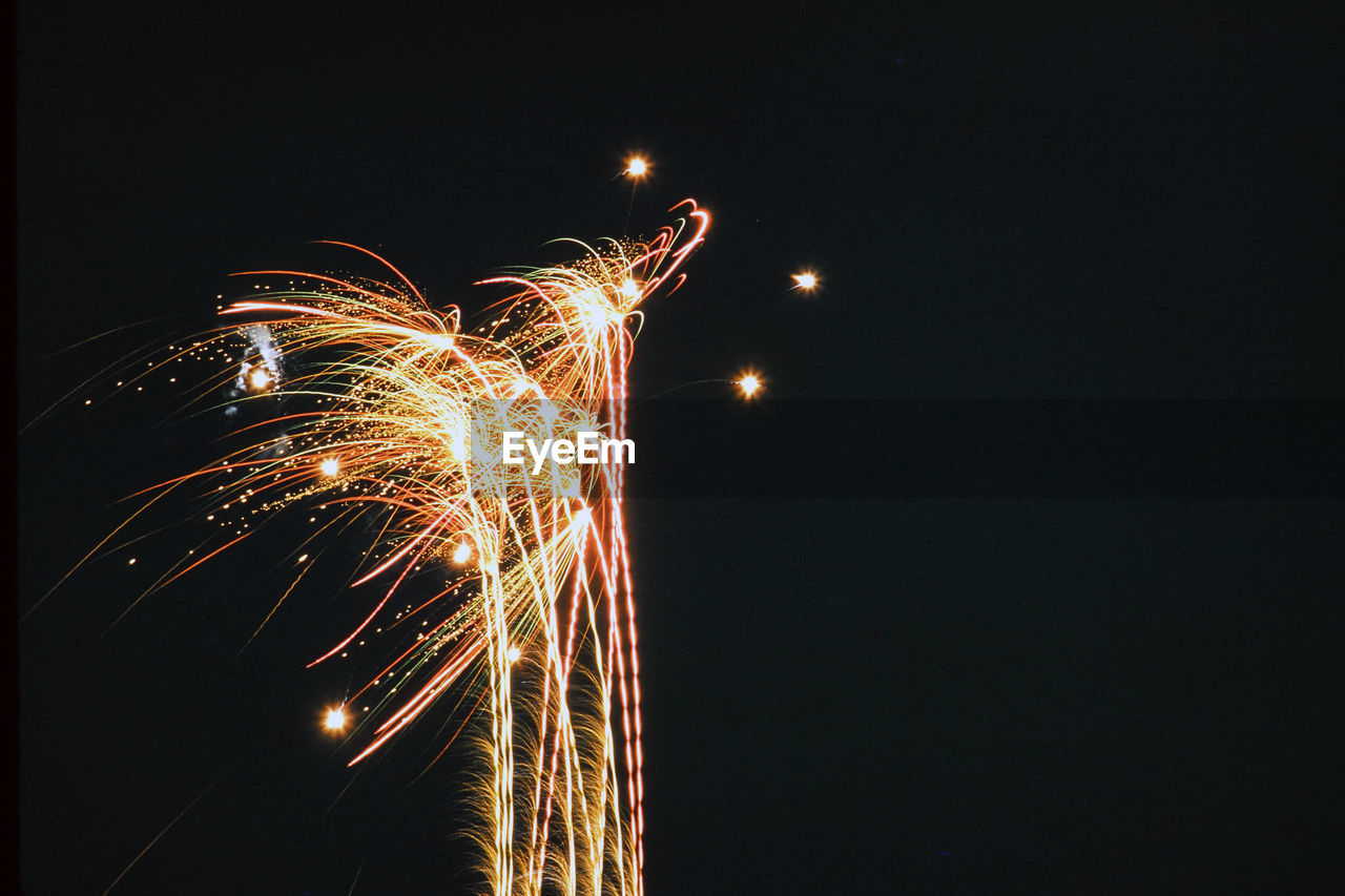 Low angle view of firework display at night