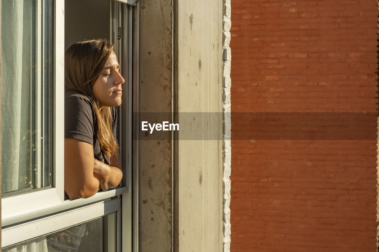 Woman in the windows during quarantine