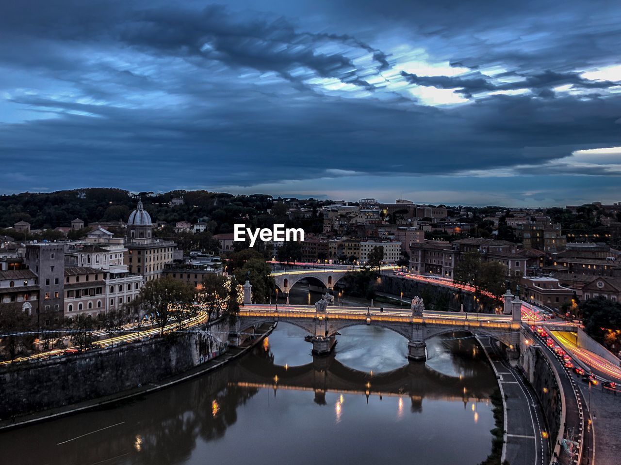 Bridge over river with buildings in background