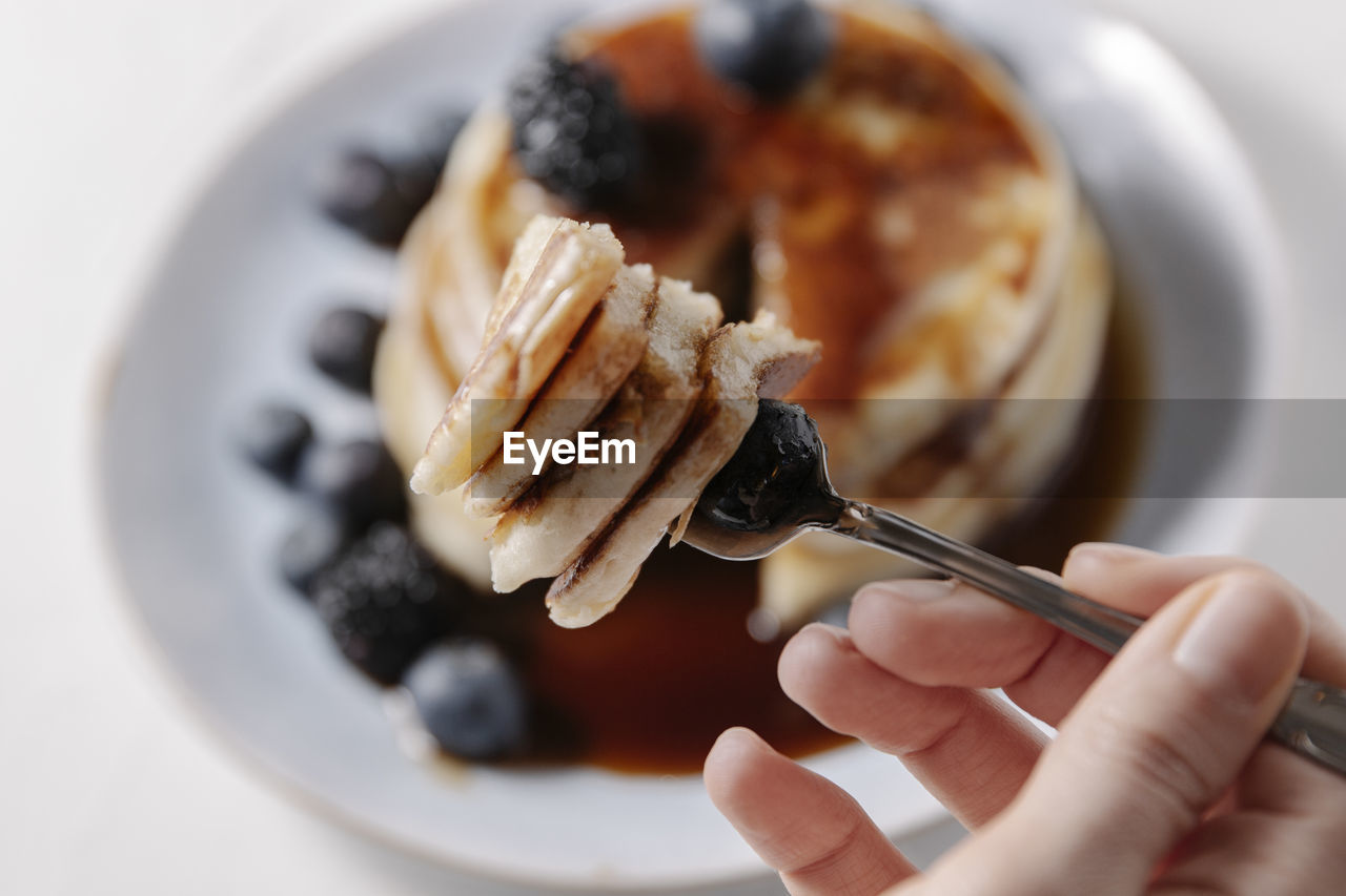 Pancakes with blueberry on a fork