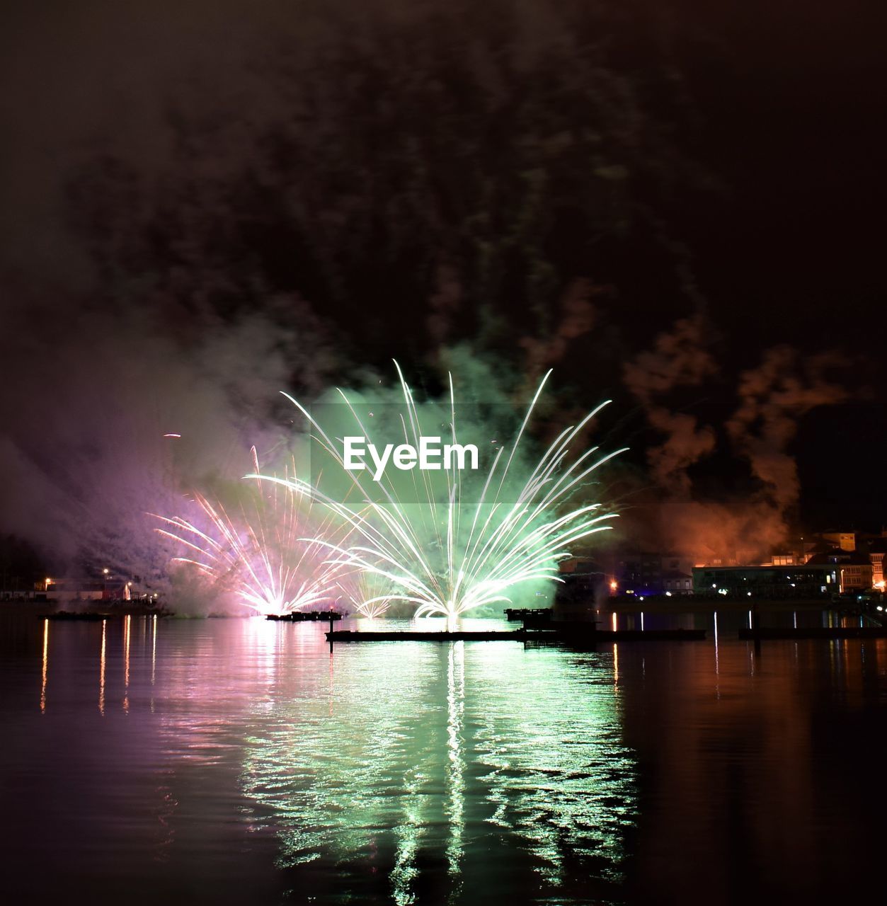 View of firework display over river at night