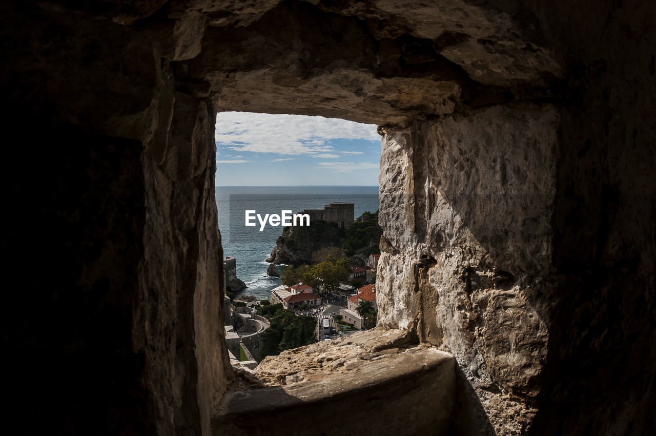 ROCK FORMATION BY SEA AGAINST SKY SEEN THROUGH CAVE