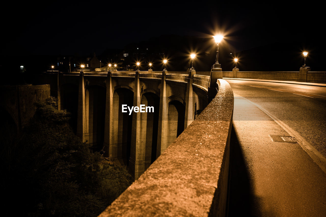 Illuminated highway bridge at night