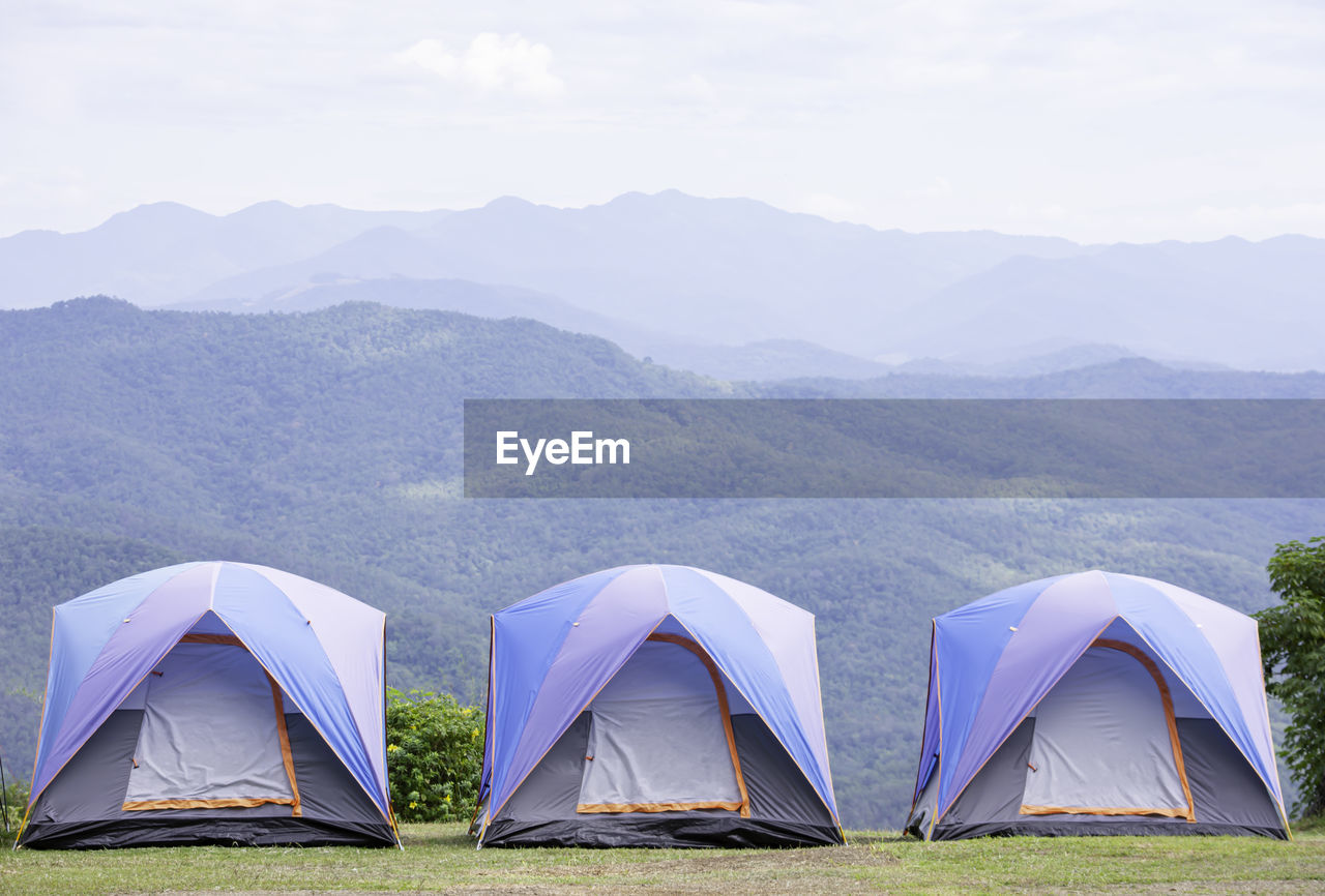 TENT IN MOUNTAINS AGAINST SKY