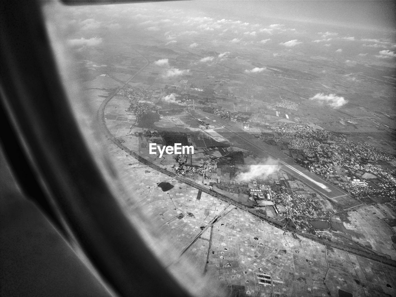 window, transportation, aerial view, mode of transport, no people, airplane, air vehicle, day, flying, outdoors, vehicle part, cityscape, water, airplane wing, close-up, nature, sky