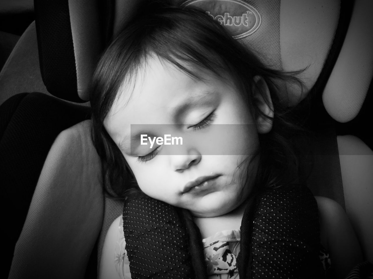 Close-up of cute girl sleeping in car