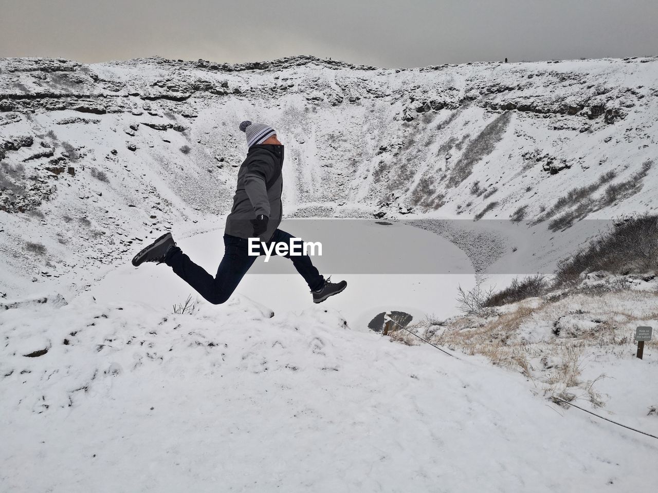 FULL LENGTH OF PERSON ON SNOWCAPPED MOUNTAIN