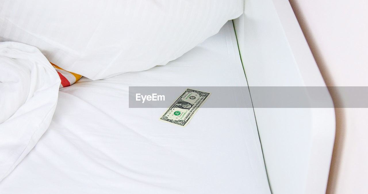 bed, indoors, white, wealth, business, furniture, finance, clothing, technology, bedroom, high angle view, currency, communication