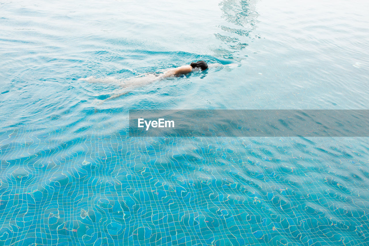 High angle view of woman swimming in pool