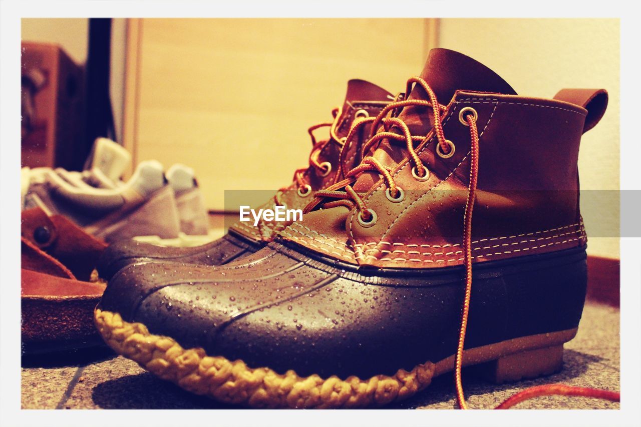 CLOSE-UP OF SHOES ON THE TABLE