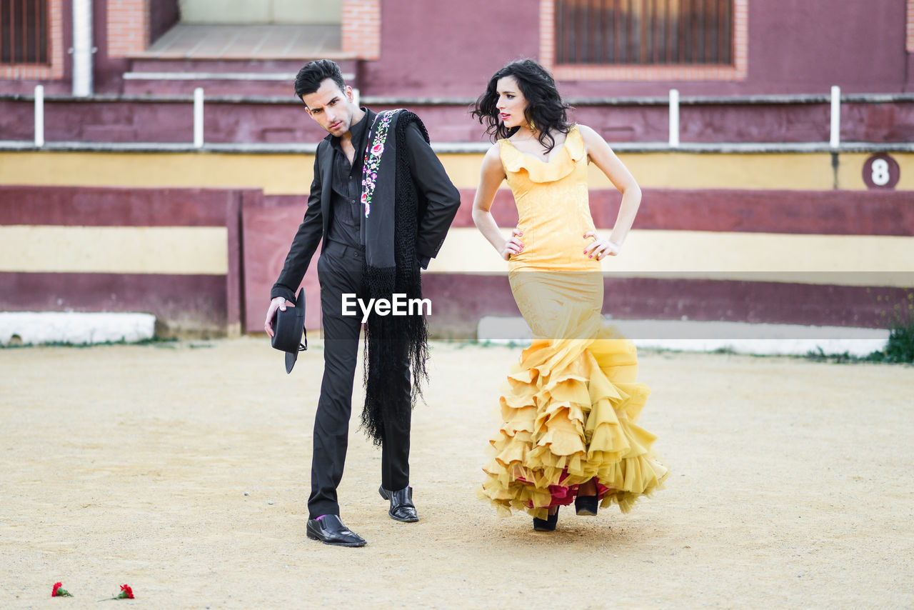 Full length of couple standing at stadium