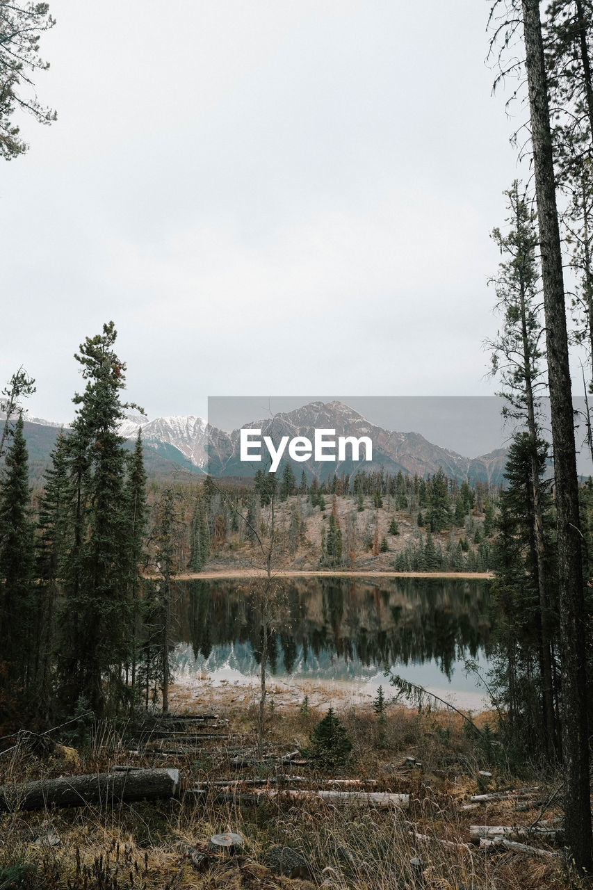 Scenic view of lake by mountains against sky