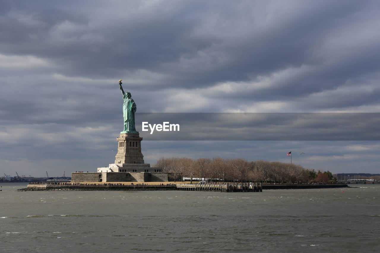 Statue of liberty against cloudy sky