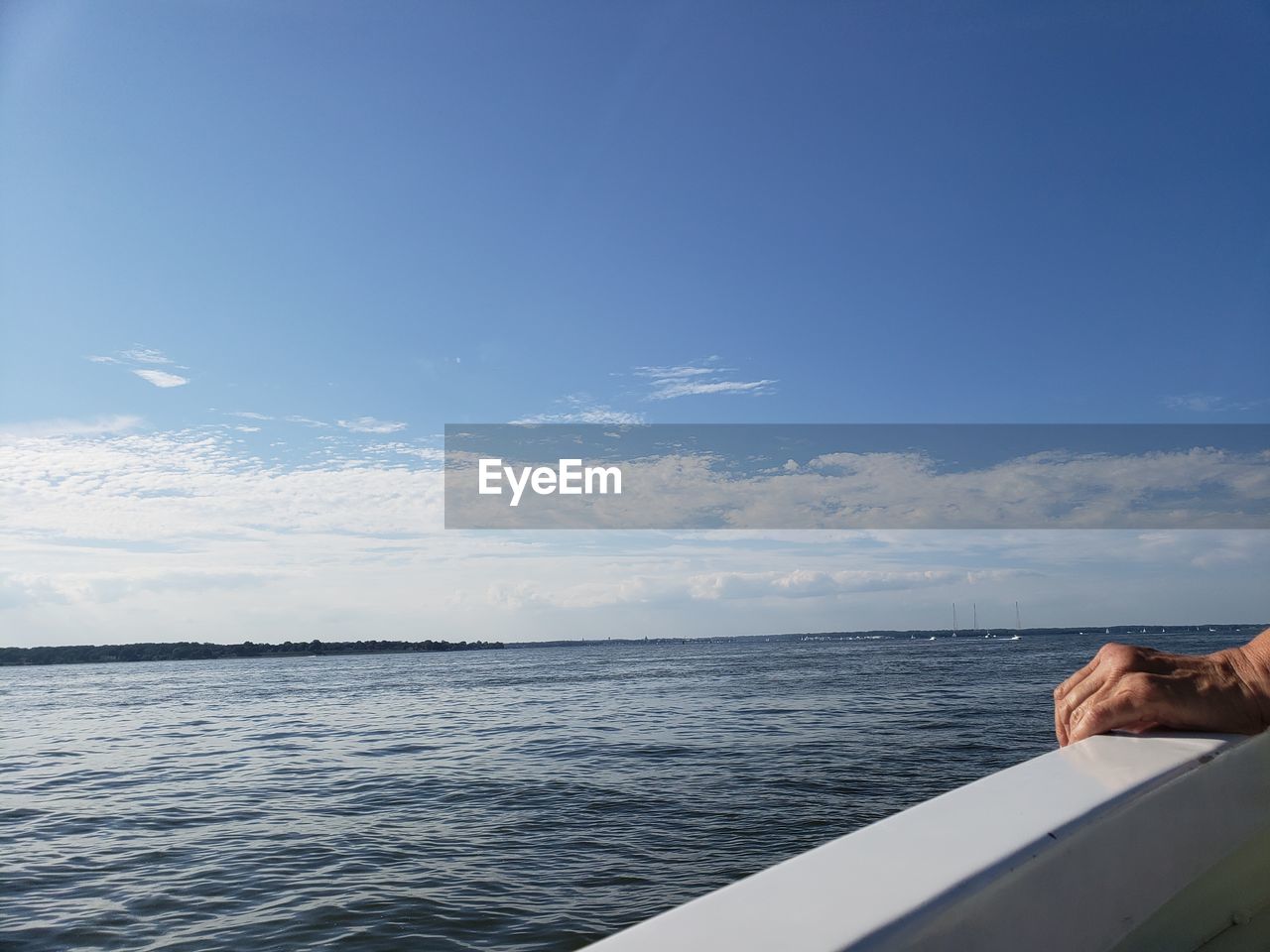 MAN BY SEA AGAINST BLUE SKY