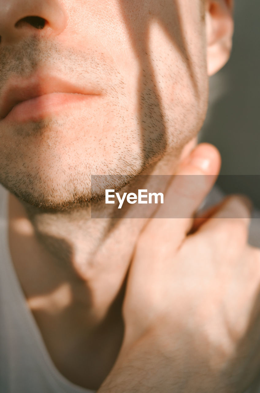 CLOSE-UP PORTRAIT OF YOUNG MAN WITH TATTOO