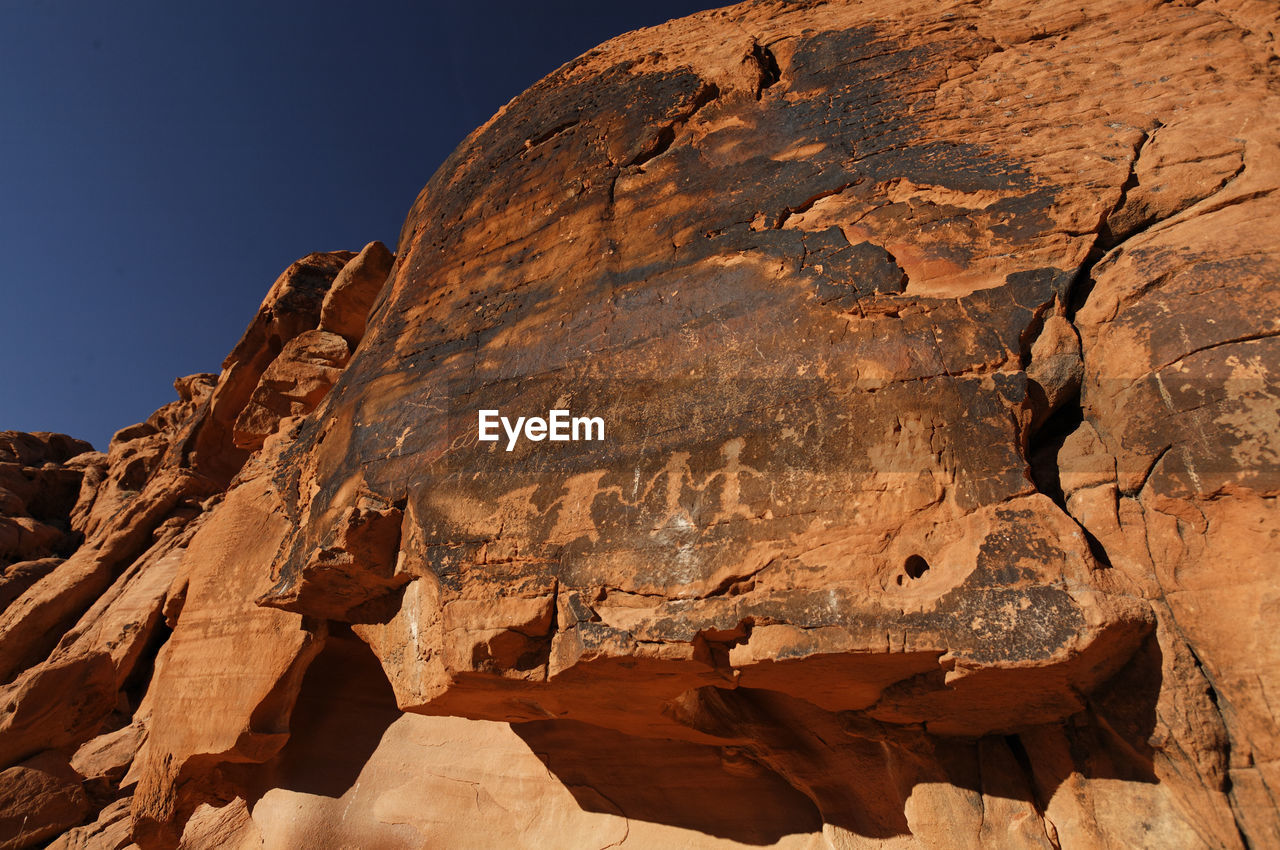 LOW ANGLE VIEW OF ROCK FORMATIONS AGAINST SKY