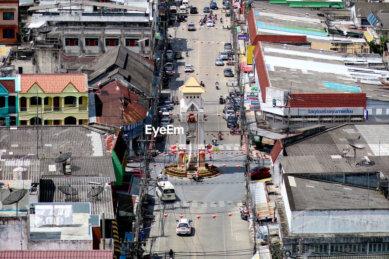 HIGH ANGLE VIEW OF BUILDINGS BY ROAD IN CITY