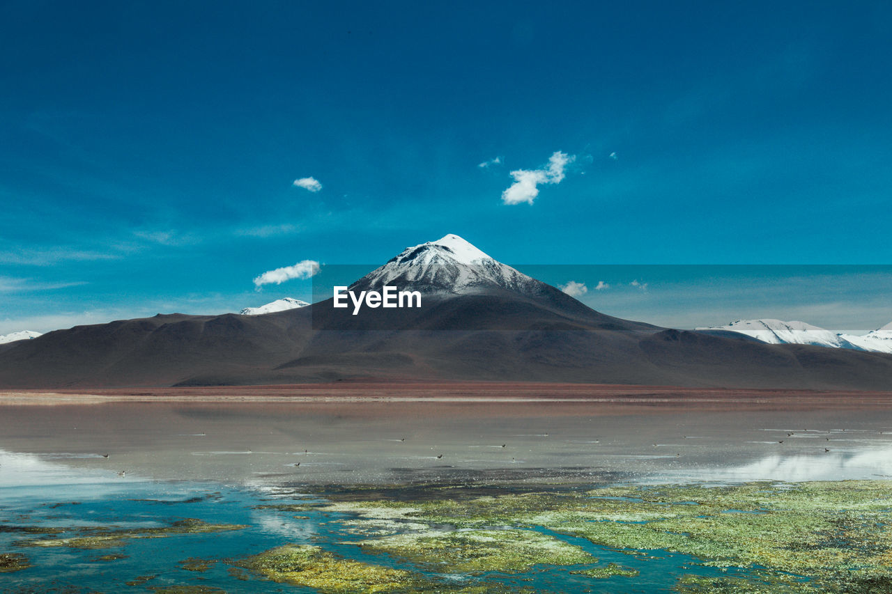 View of snowcapped mountain against cloudy sky