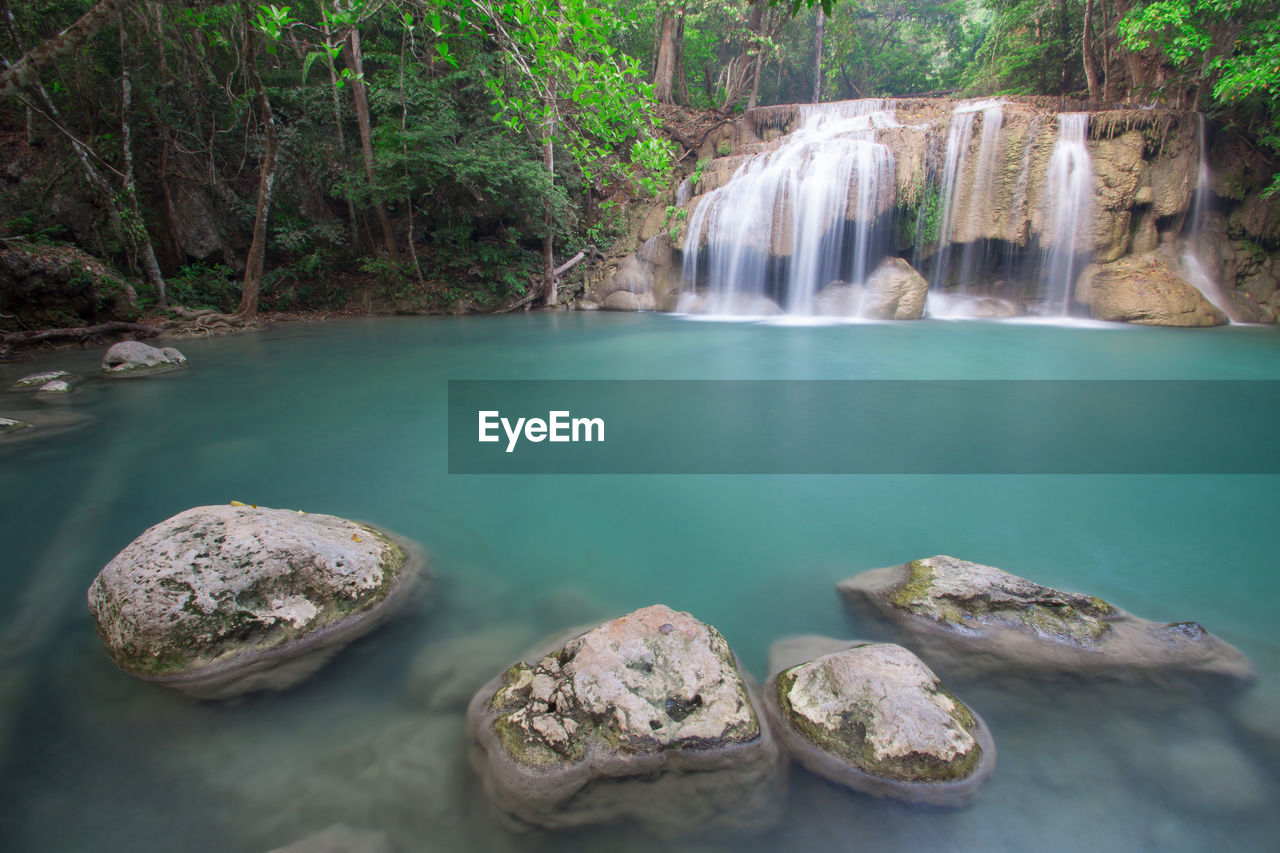 PANORAMIC VIEW OF WATERFALL IN FOREST