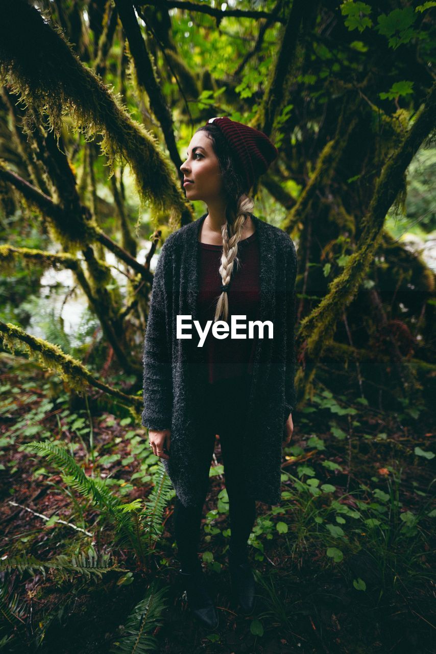 Woman looking away in forest