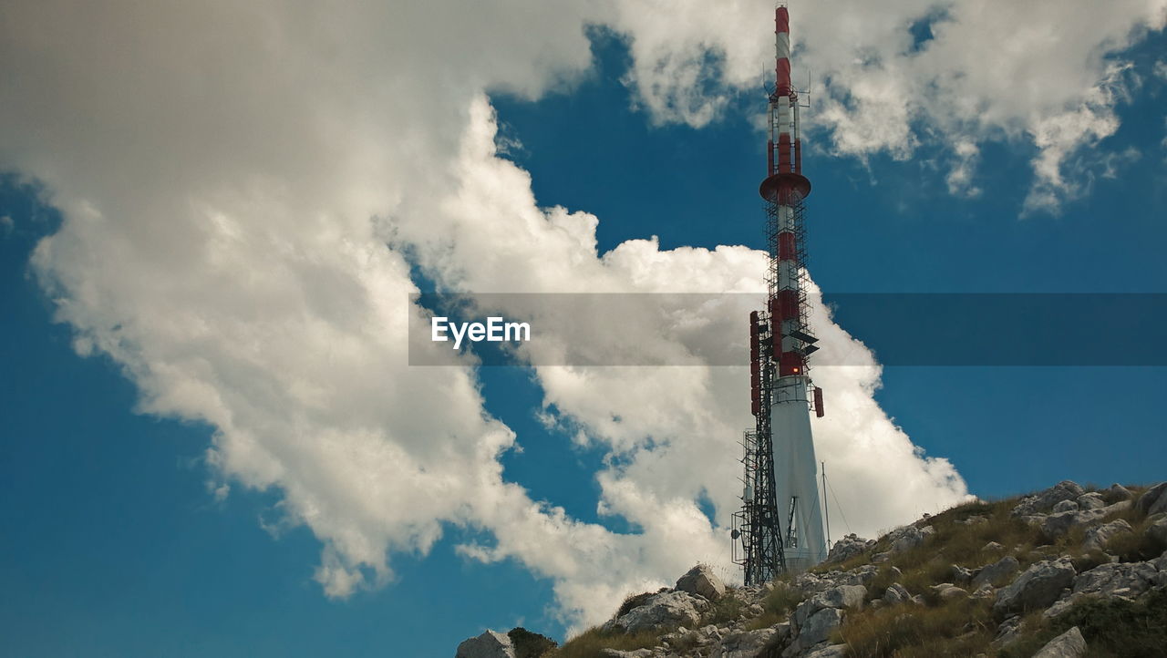 Low angle view of communications tower against sky