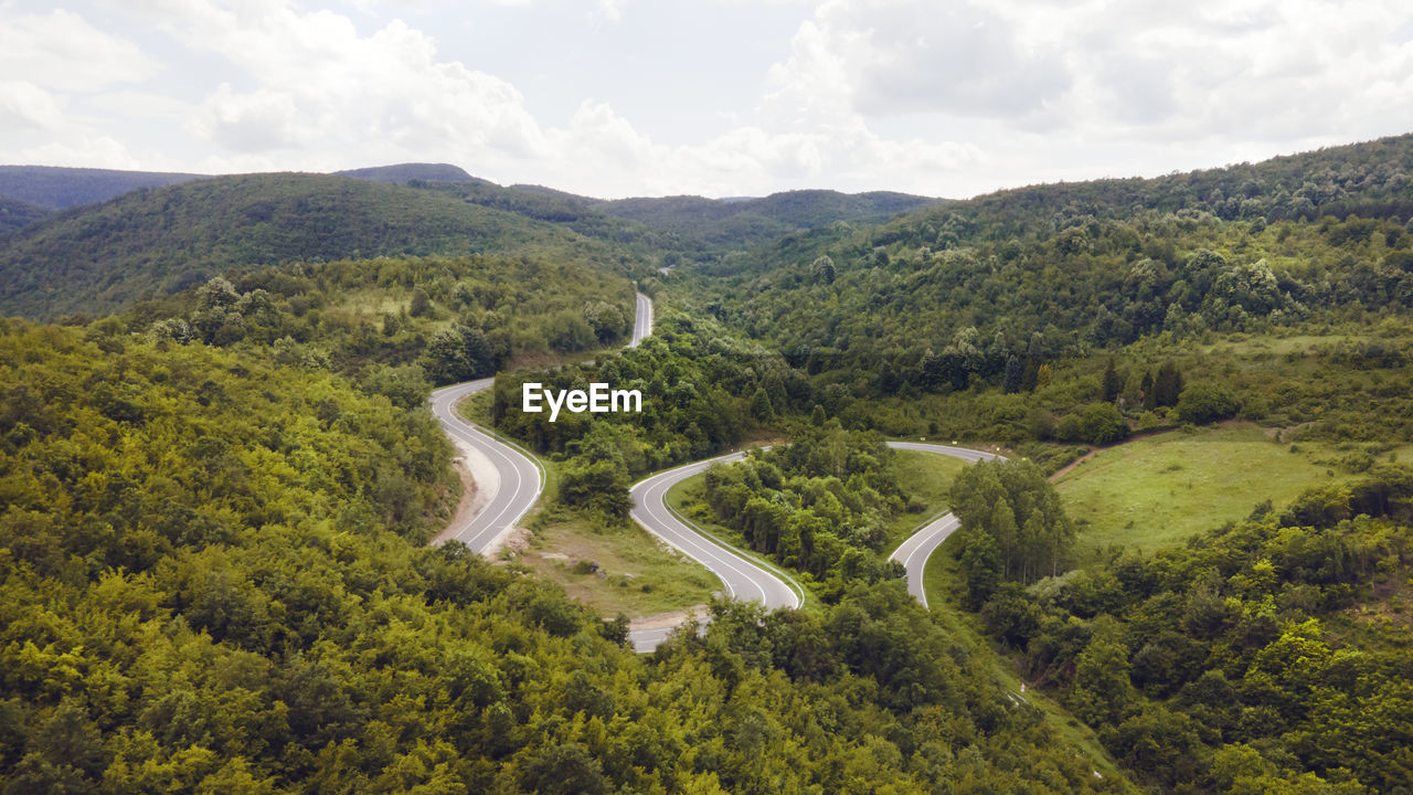 HIGH ANGLE VIEW OF ROAD AMIDST MOUNTAINS AGAINST SKY