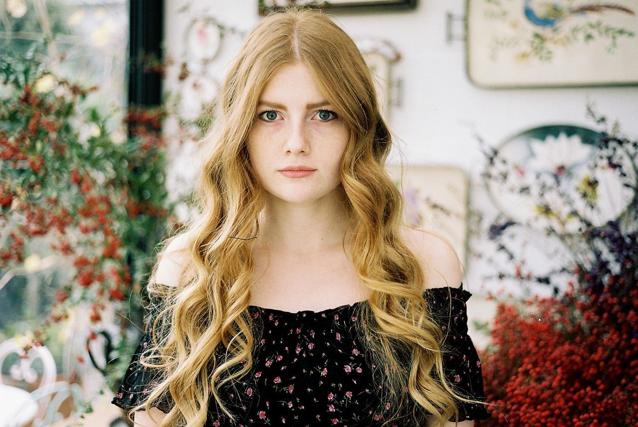 Portrait of beautiful young woman with long blond hair