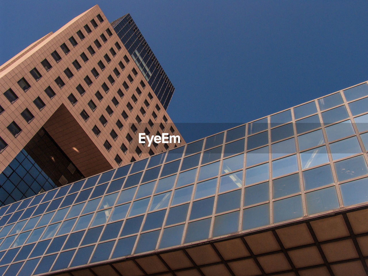 LOW ANGLE VIEW OF BLUE SKY WITH REFLECTION OF BUILDING AGAINST CLEAR BACKGROUND