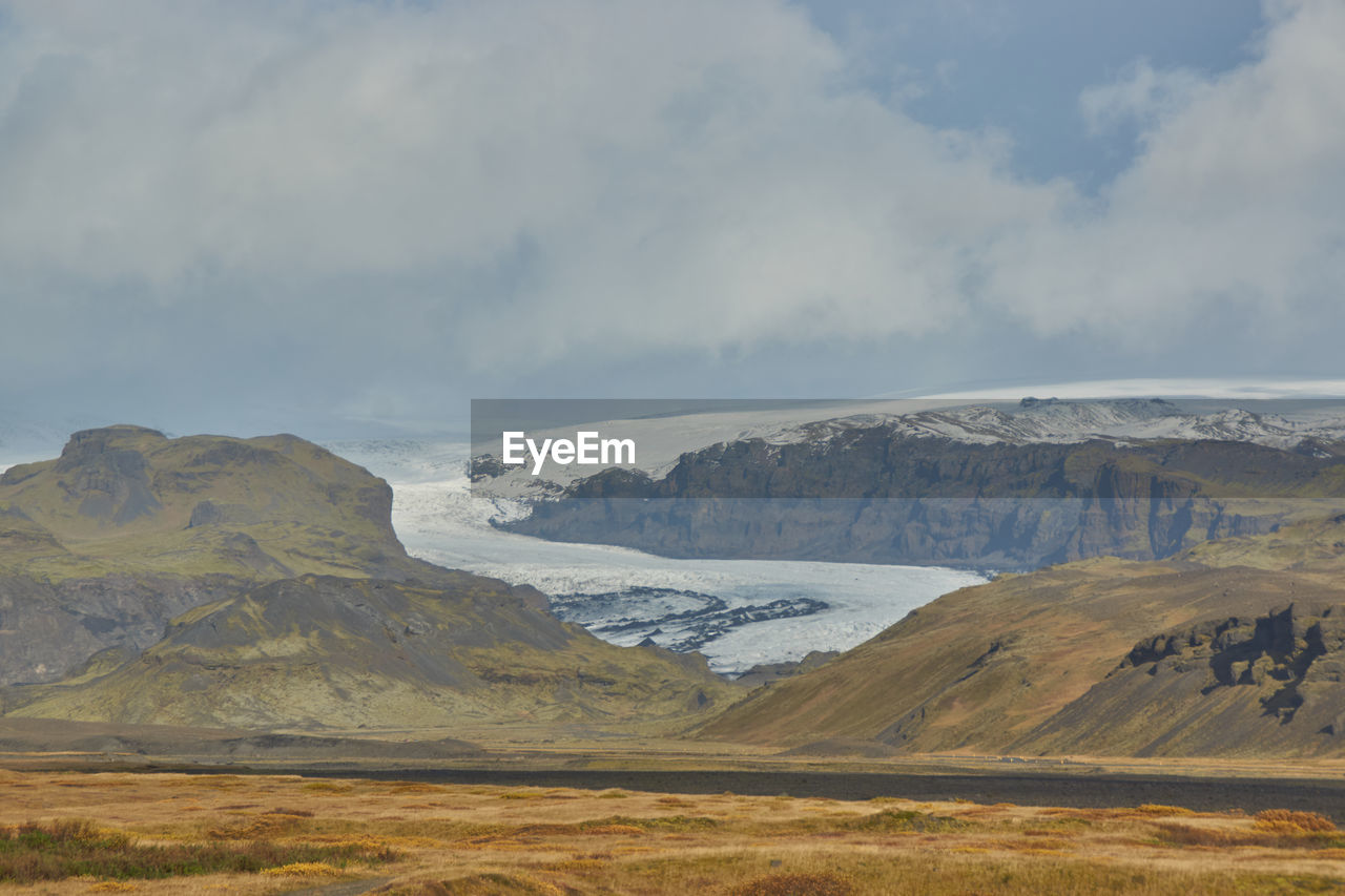 Scenic view of landscape and mountains against sky