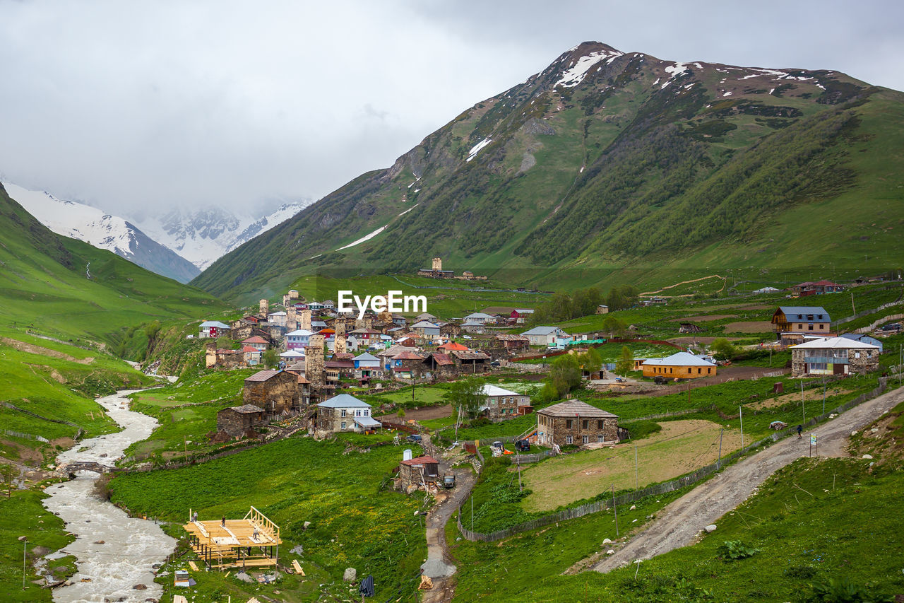 SCENIC VIEW OF VILLAGE AMIDST BUILDINGS