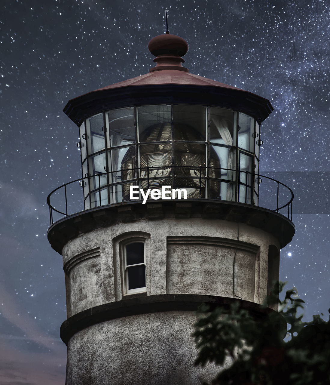 Low angle view of lighthouse and stars at night