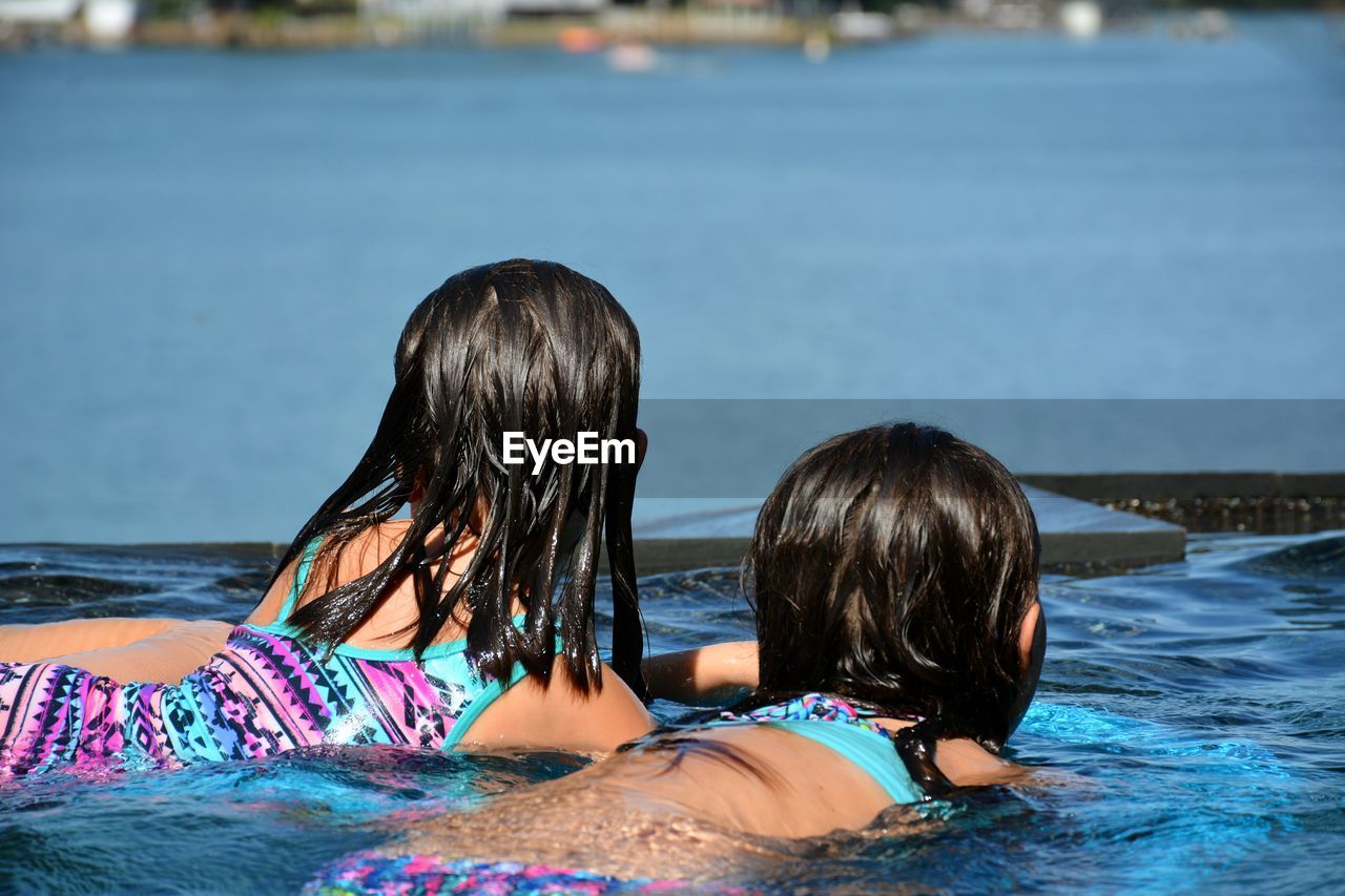 Girls swimming in lake