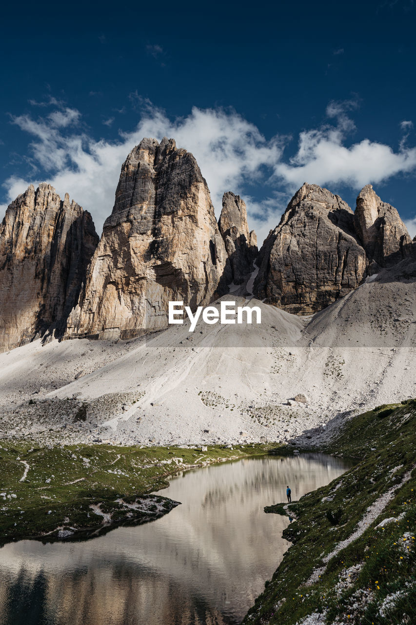Men watching the lake in the dolomites