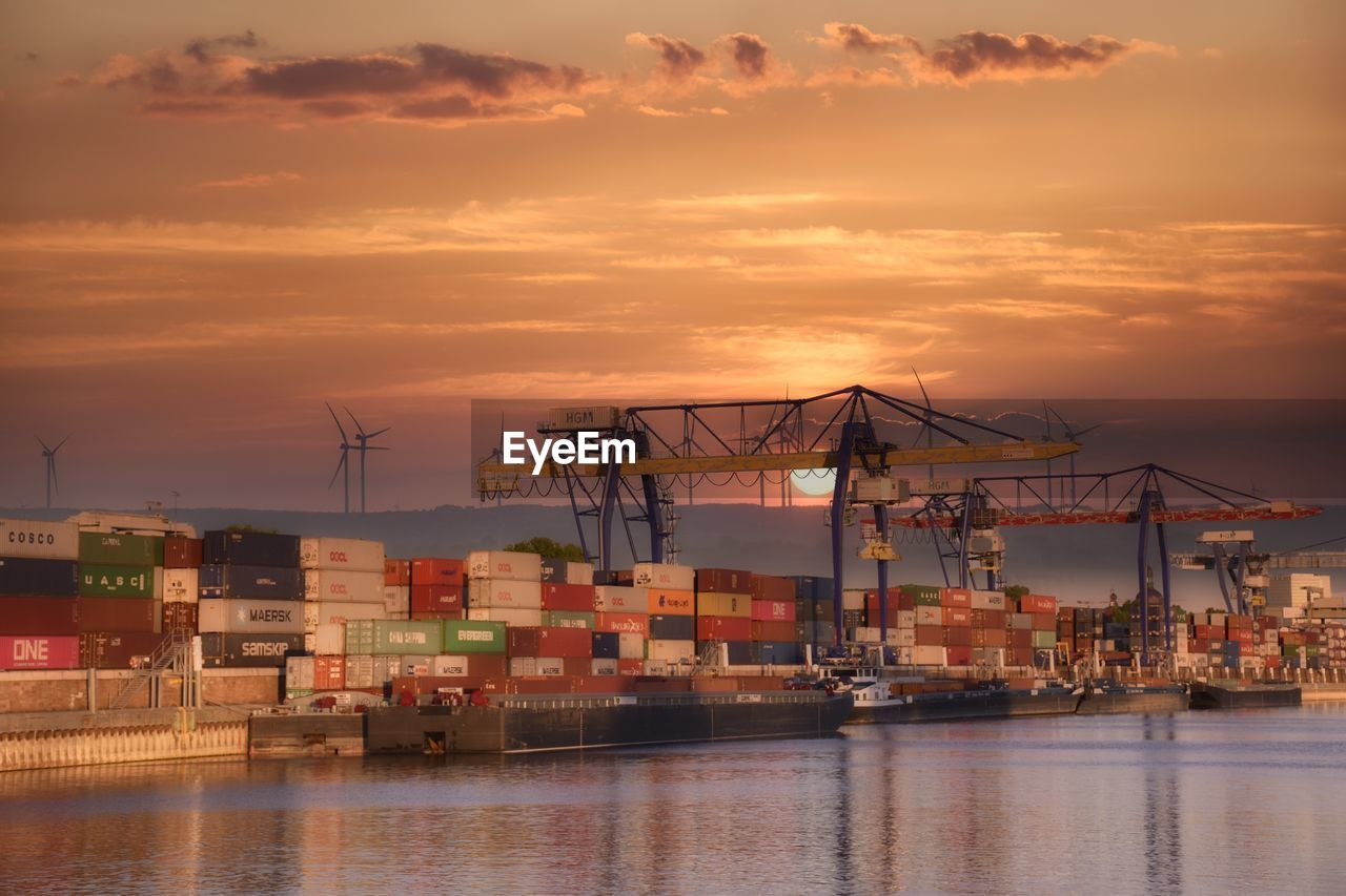 CRANES AT HARBOR DURING SUNSET