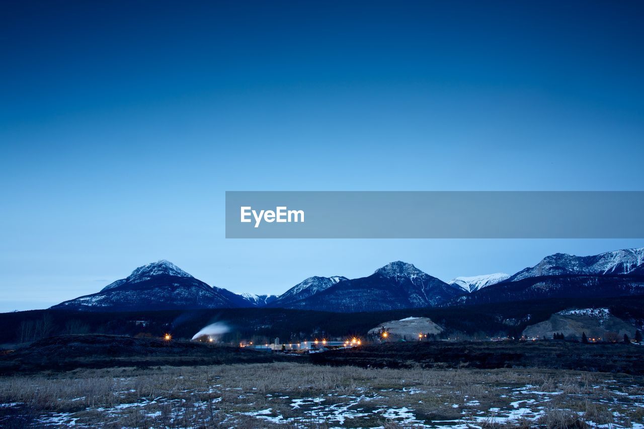 Illuminated lights on field against clear sky at banff national park