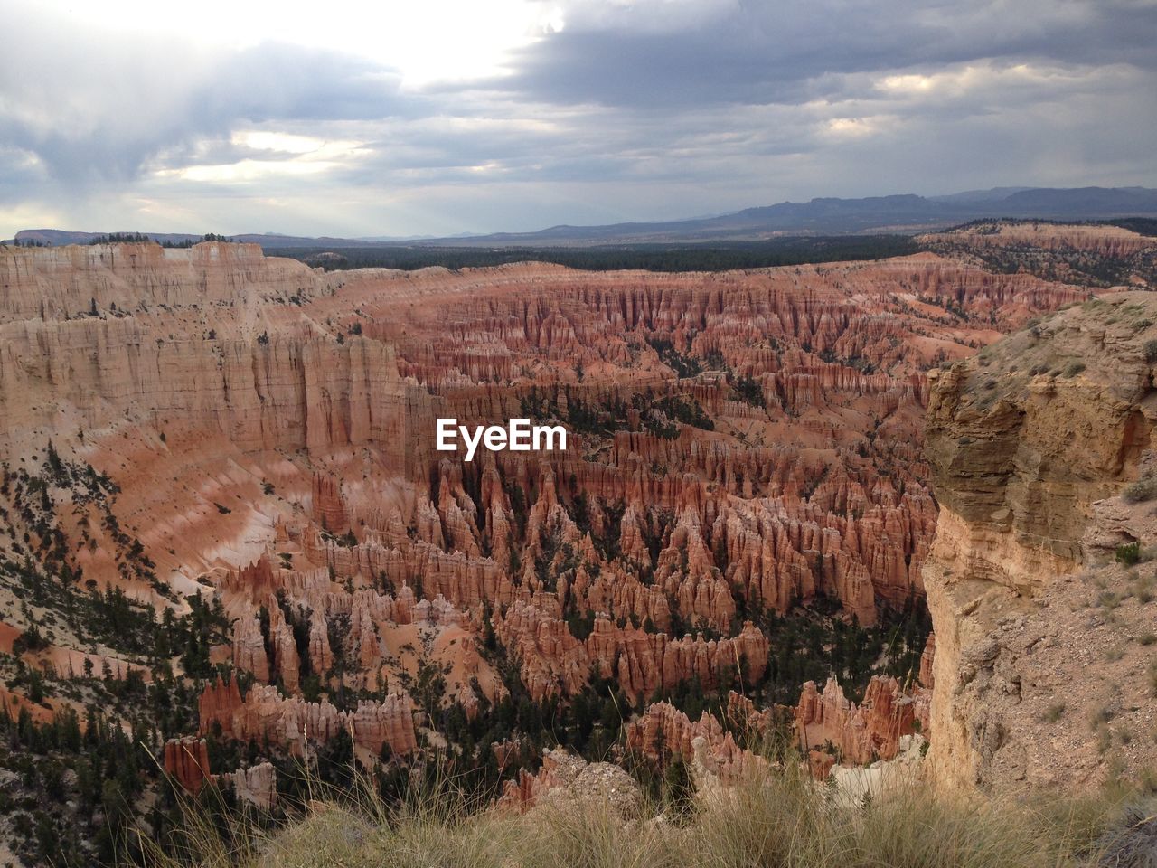 Scenic view of landscape against cloudy sky