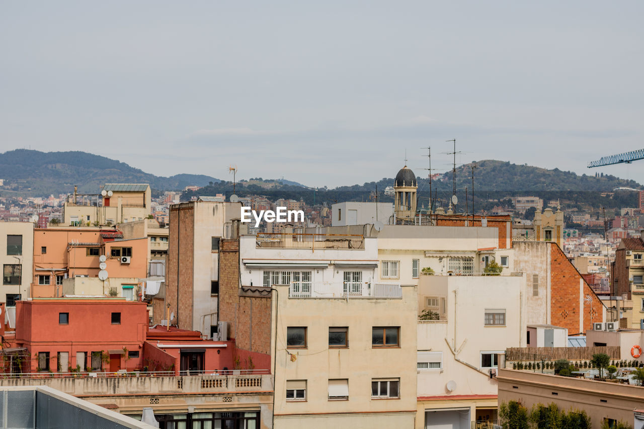 HIGH ANGLE VIEW OF RESIDENTIAL BUILDINGS AGAINST SKY