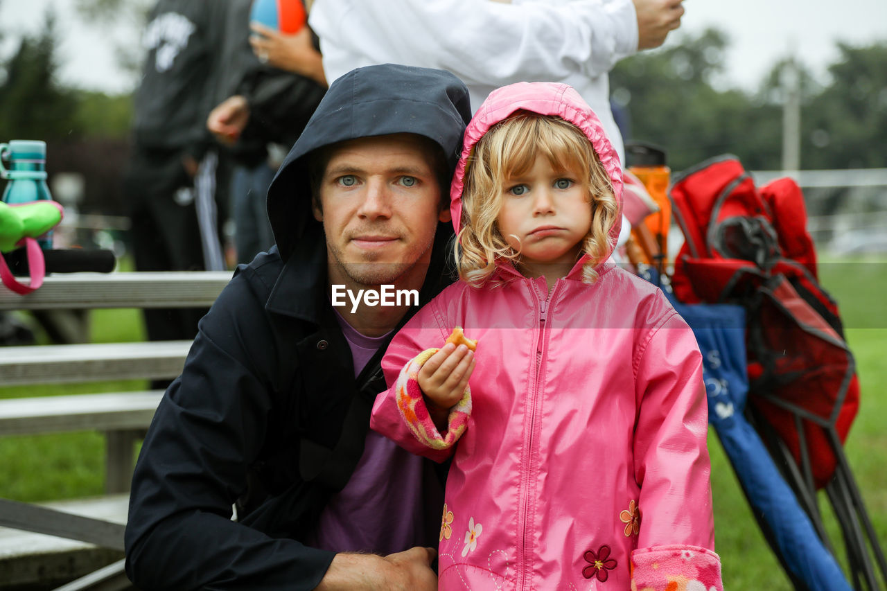 Portrait of father and daughter outside at sports activity