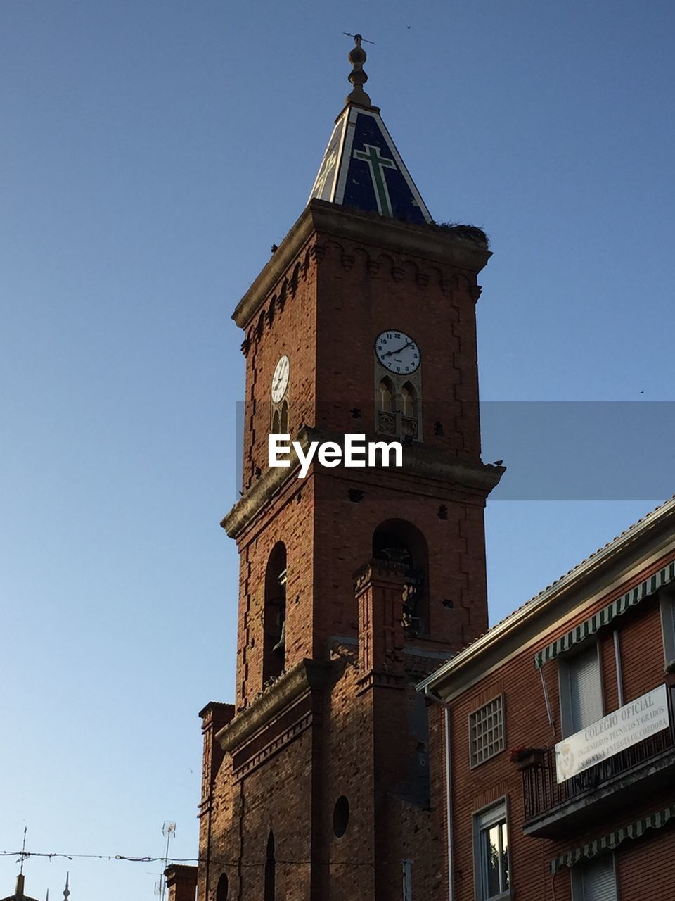 LOW ANGLE VIEW OF BELL TOWER AGAINST CLEAR BLUE SKY