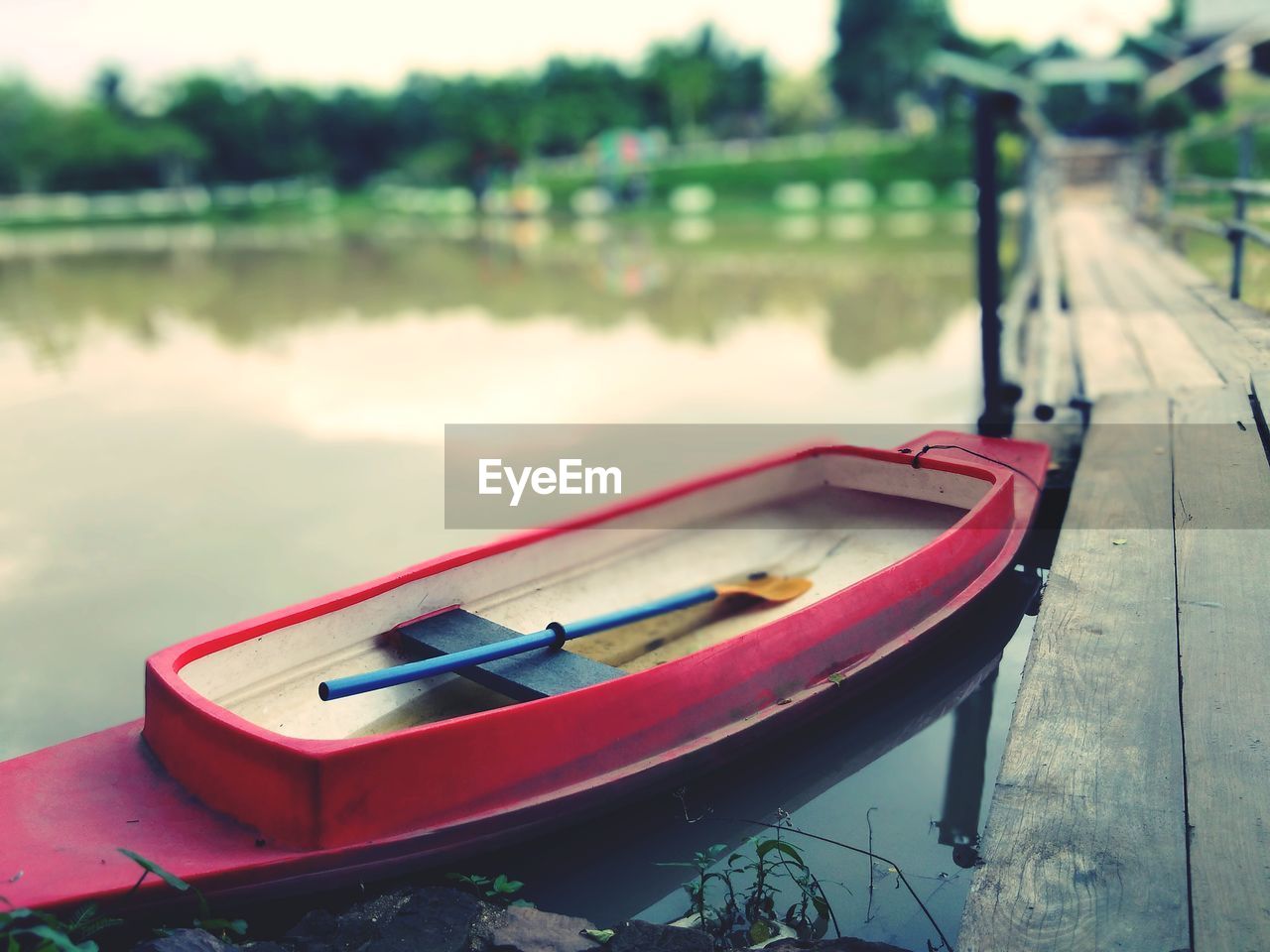 Boat moored at pier on lake